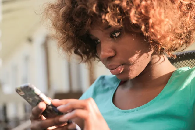 Woman Using Smartphone During Daylight