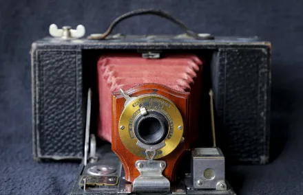 Black and Red Camera on Blue Textile