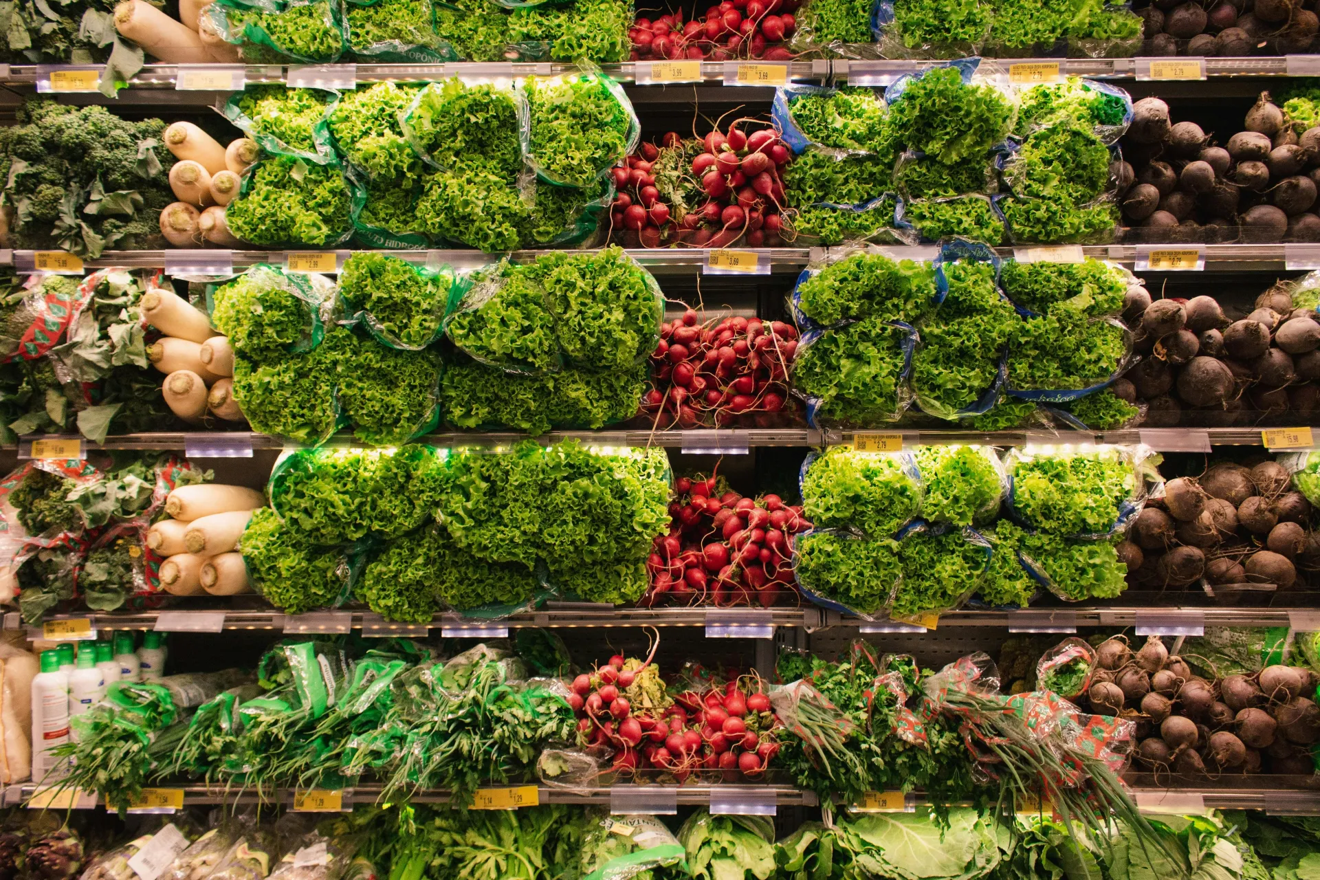 Colorful assortment of fresh vegetables arranged on supermarket shelves, perfect for healthy eating themes.
