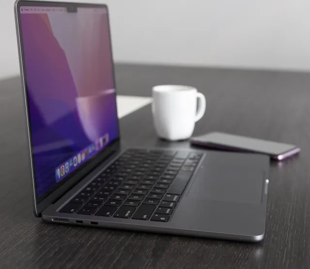 Computer Laptop Beside the Cellphone and Cup