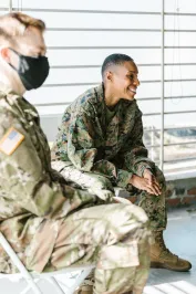 Photo of Soldiers Sitting Beside Each Other