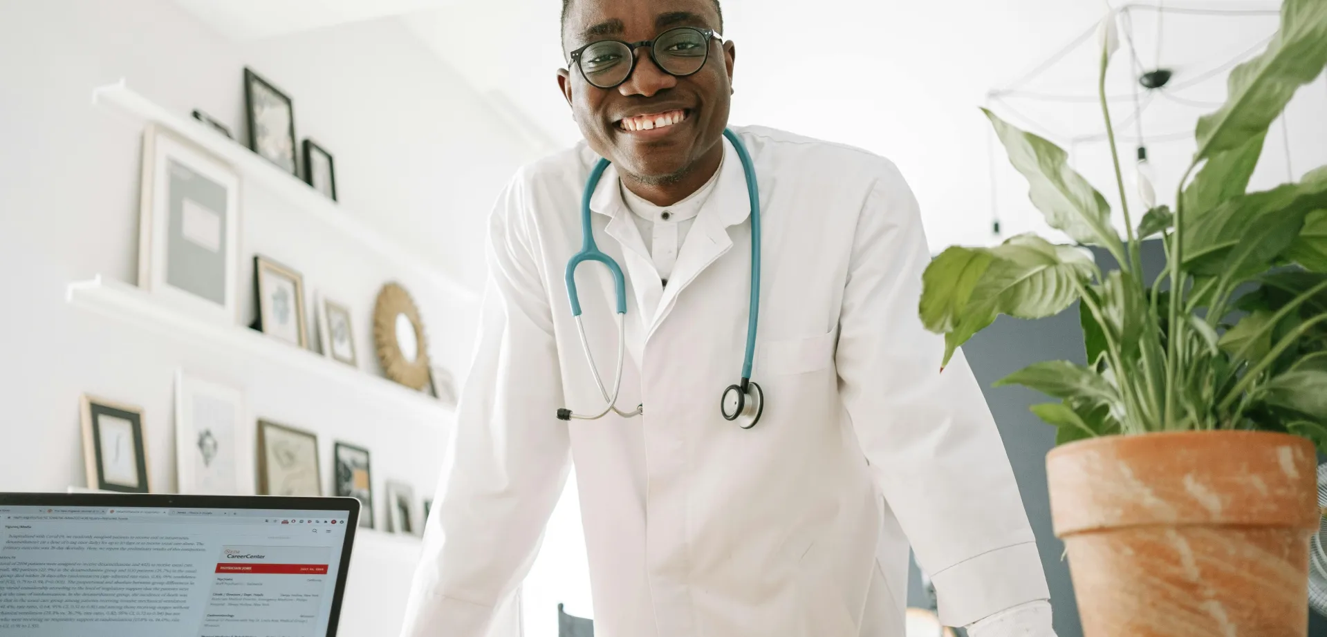 A Doctor Smiling while Leaning on the Table