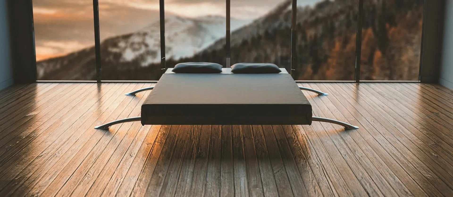 Minimalist bedroom with large windows offering a breathtaking mountain view during sunset.