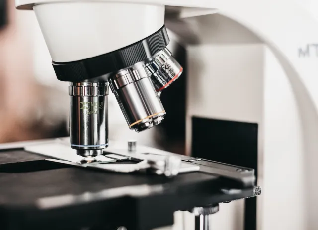 White and black laboratory microscope for assessing test results.