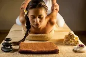 Crop therapist massaging foot of client