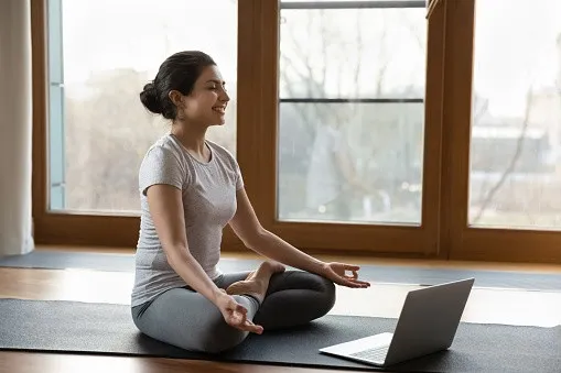 Girl Meditating with her laptop