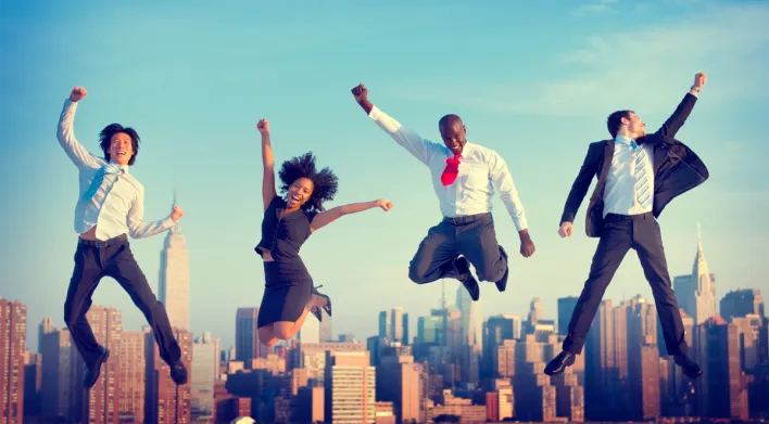 Four individuals jumping with joy expressing their excitement because people are keeping love present in the world.