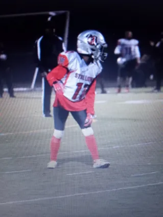 Football Players Wearing Jersey Outfits on Field