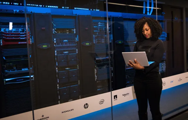 Software Engineer Standing Beside Server Racks