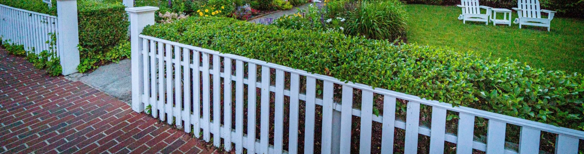 Gray Scale Photo of White Fence