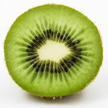 Close-up of a fresh kiwi fruit slice showcasing its vibrant green and black seeds.