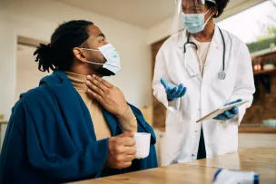 A female doctor consulting a patient in a modern medical office setting.