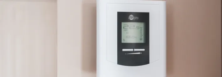 White Thermostat Hanging on the Wall