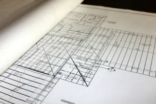 Man in Plaid Shirt Wearing Hard Hat while Looking at Camera