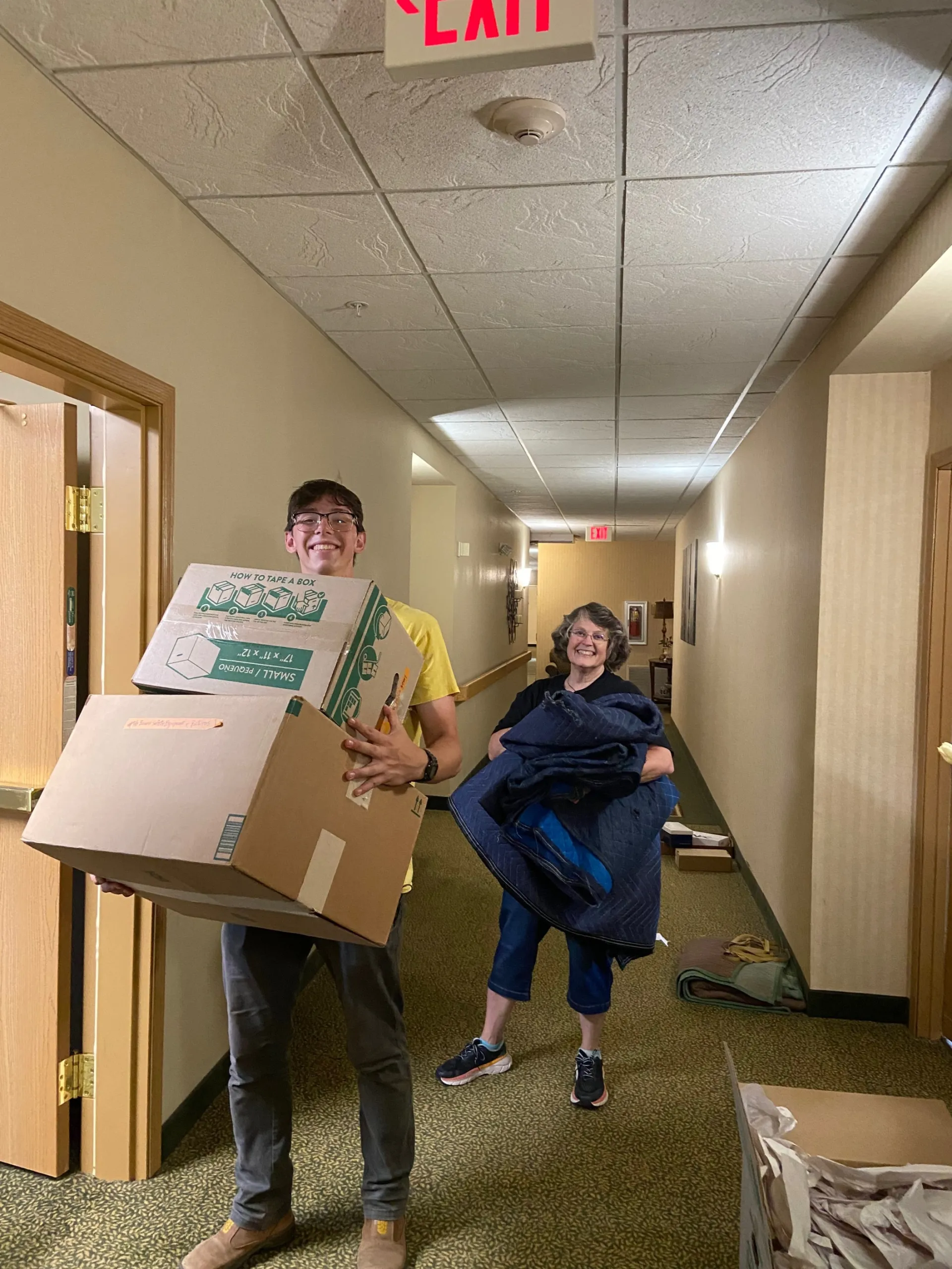 Exited diverse couple relocating in new apartment