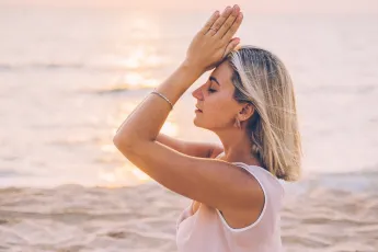 A Woman Meditating at the Beach