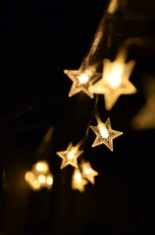 Shallow Focus Photography of Yellow Star Lanterns