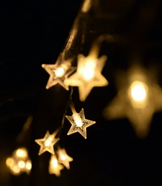 Shallow Focus Photography of Yellow Star Lanterns