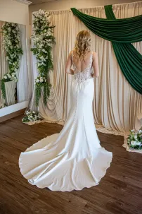 Back of wedding dress with lace bodice, scoop back, and simple crepe train