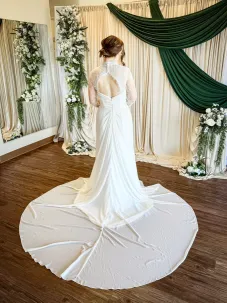Back of wedding dress with simple chiffon skirt with lace jacket overlay and keyhole back.