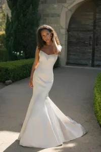 Simple, sleek satin fit-and-flare gown with natural waist, strapless cat-eye neckline adorned with beading