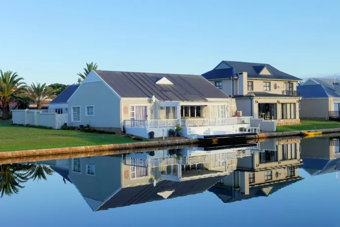 White Single-story Houses Beside Body of Water