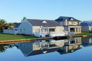White Single-story Houses Beside Body of Water