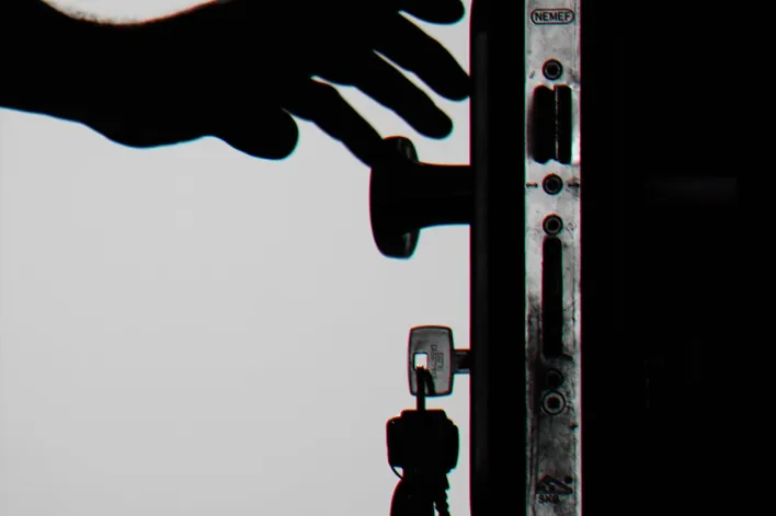 Silhouette Photo of Person Holding Door Knob