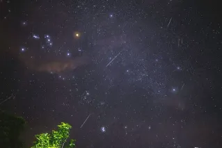 Captivating view of a meteor shower with bright stars over Malita, Philippines, highlighting the night sky beauty.