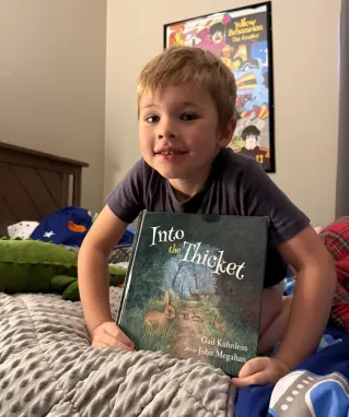 Little boy holding Into the Thicket