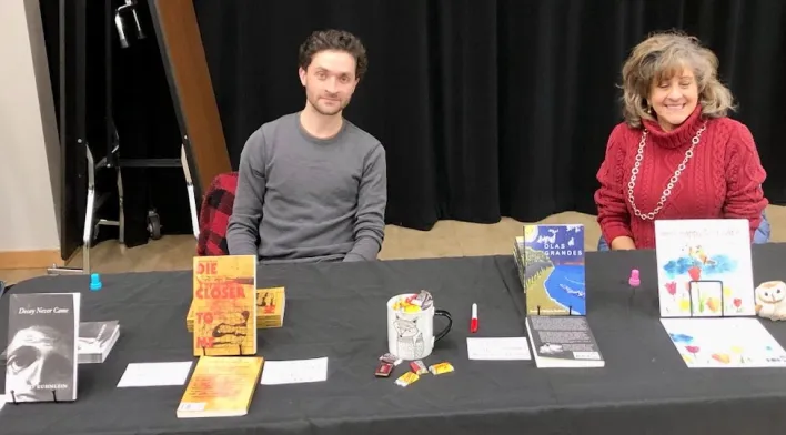 David Kuhnlein and Gail Kuhnlein at their table at a book fair in Troy, Michigan.