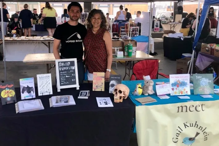 Mother and son at their book table