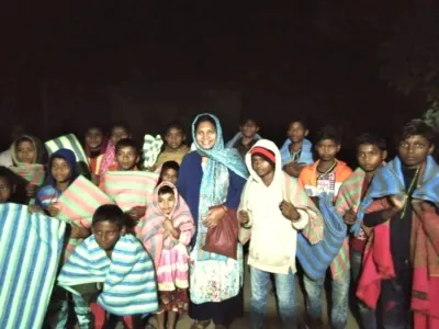 Rose, center in blue, with village children.