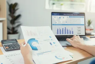 A Person Using a Laptop with a Chart on Screen