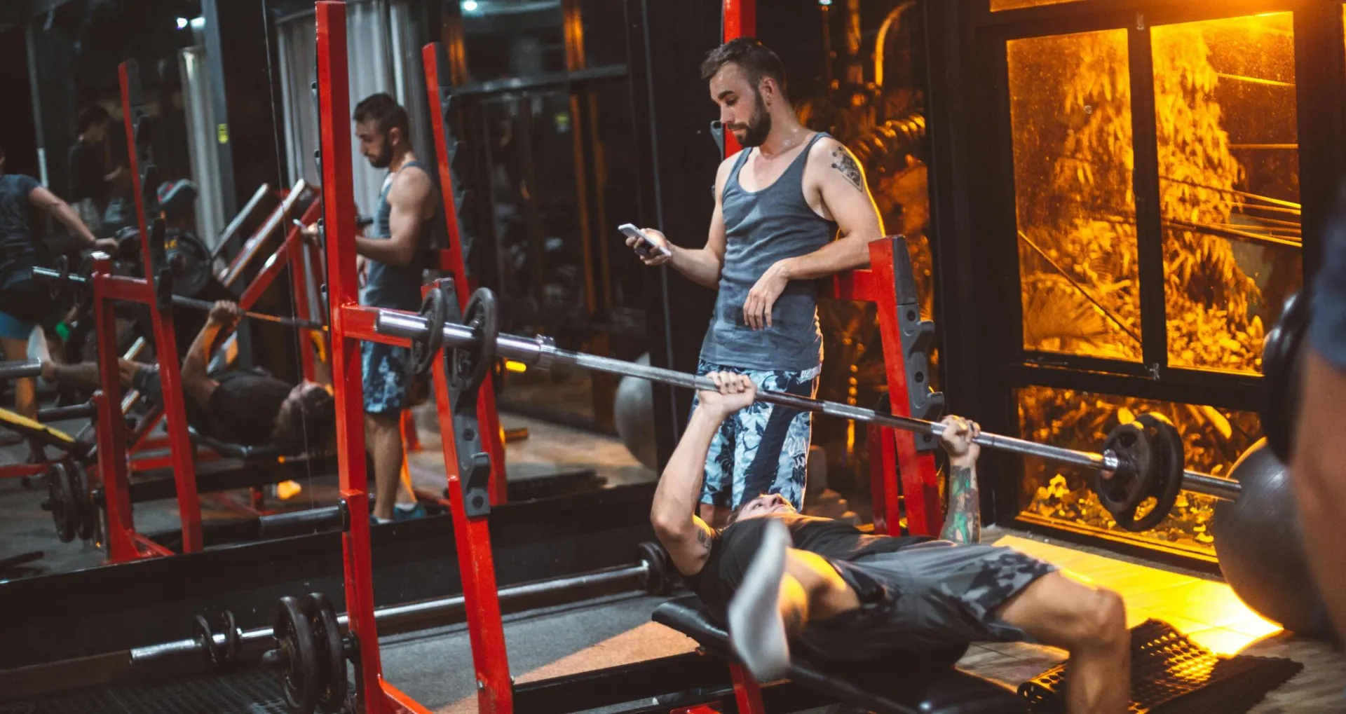 Sporty fitness trainer and man lifting barbell