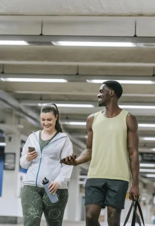 Man and Woman in Sports Clothing Walking in a Tunnel