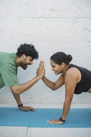 A Man and Woman Working Out Together while Doing High Five