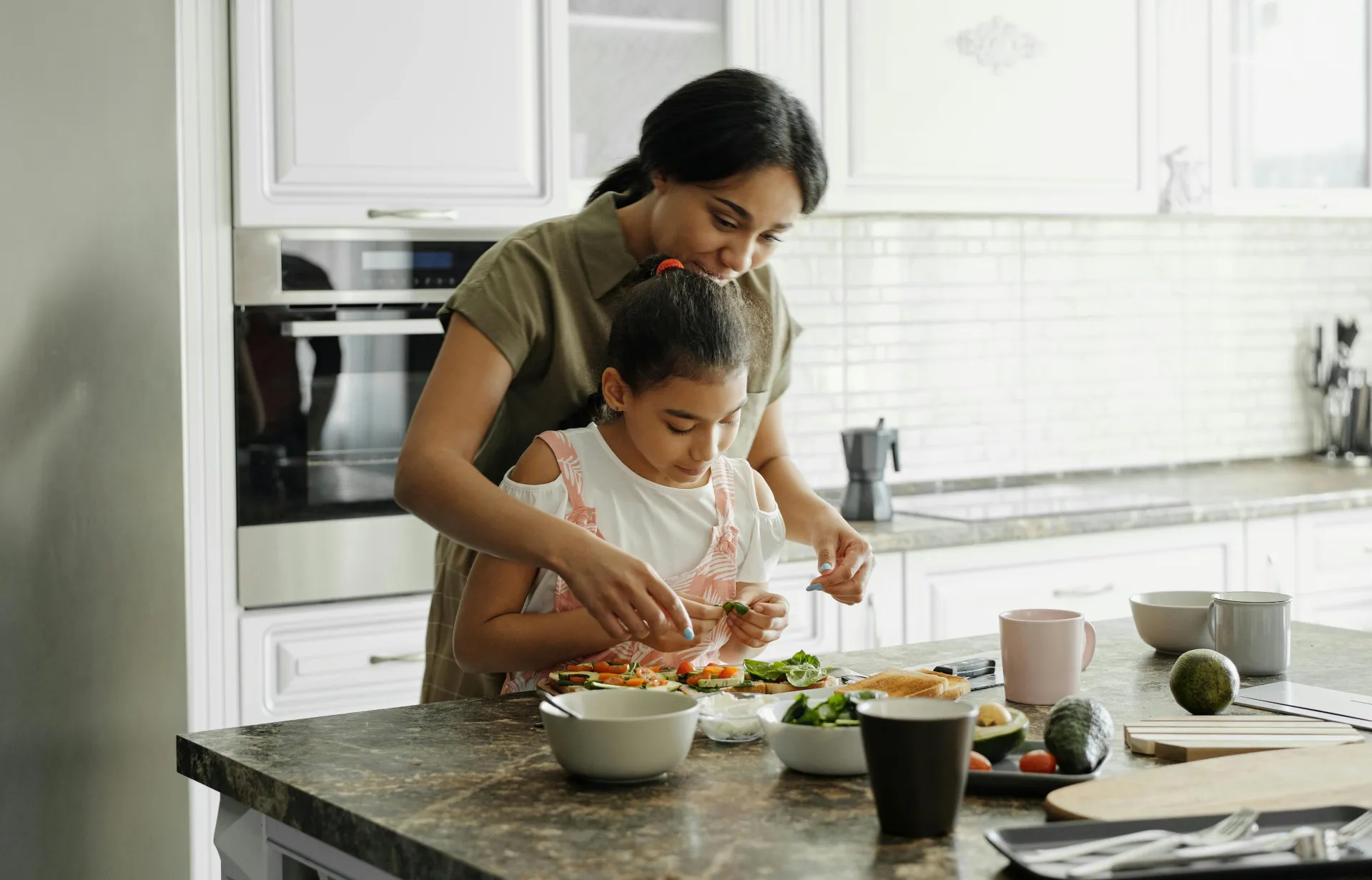 Mother and Daughter Preparing Avocado Toast