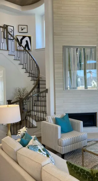A living room with a fireplace and a spiral staircase