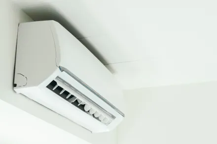 Interior of minimalist room with wooden shelves and AC