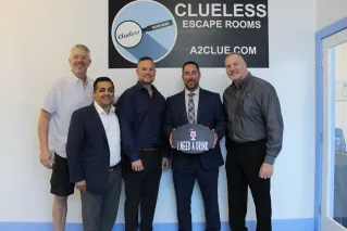 University of Michigan team building group collaborating during an escape room at Clueless Escape Rooms in Ann Arbor