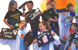 Kids celebrating a birthday party after playing an escape room at Clueless Escape Rooms in Ann Arbor