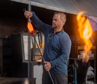 Man Using a Burner for Manufacturing Glass Items in a Workshop