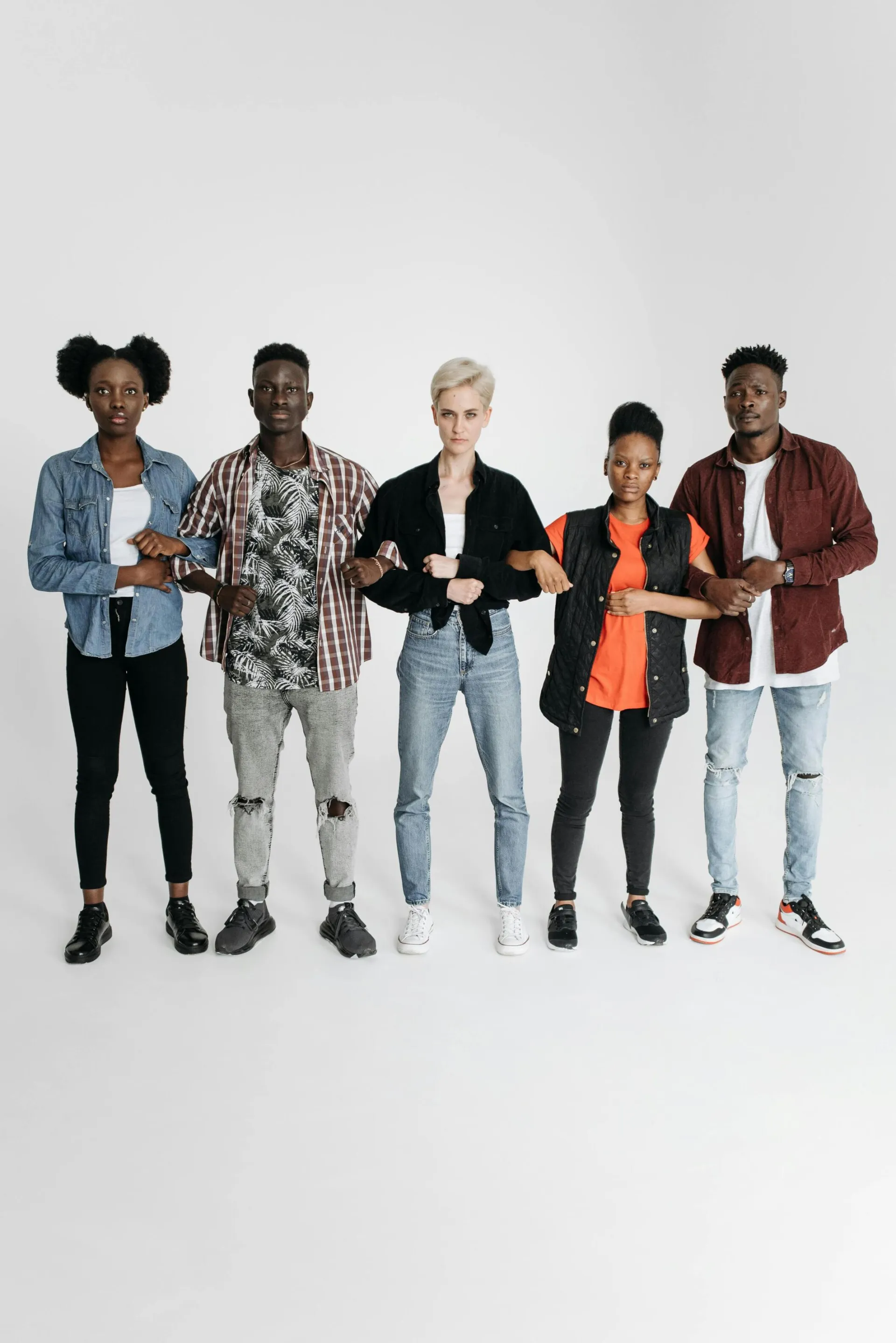 A group of adults standing together in unity against a white background.