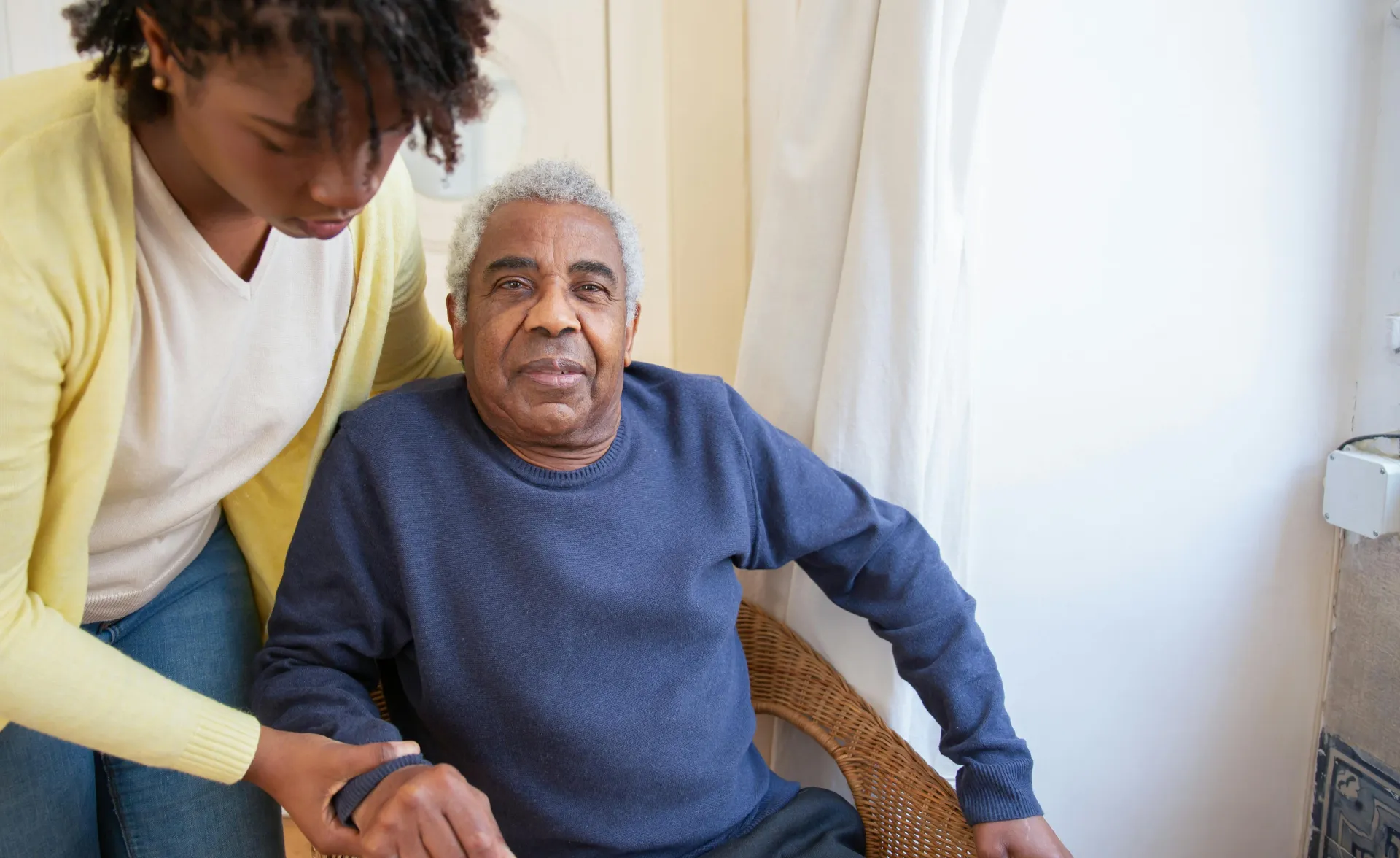 Woman Assisting Elderly Man