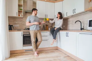 a husband and wife enjoying their newly remodeled kitchen