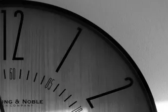 Monochrome clock with shadow play, captured in Ottawa, showcasing timeless elegance.