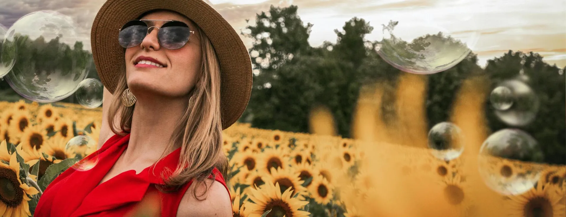 Woman Surrounded by Sunflowers Raising Hand