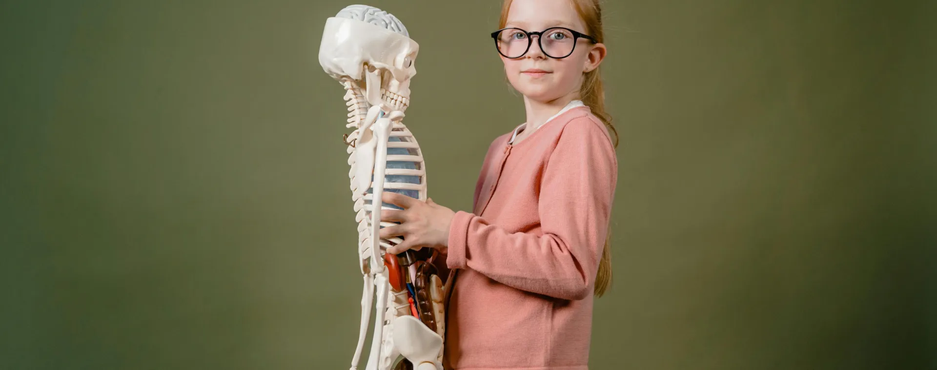 A Girl Holding a Human Skeleton