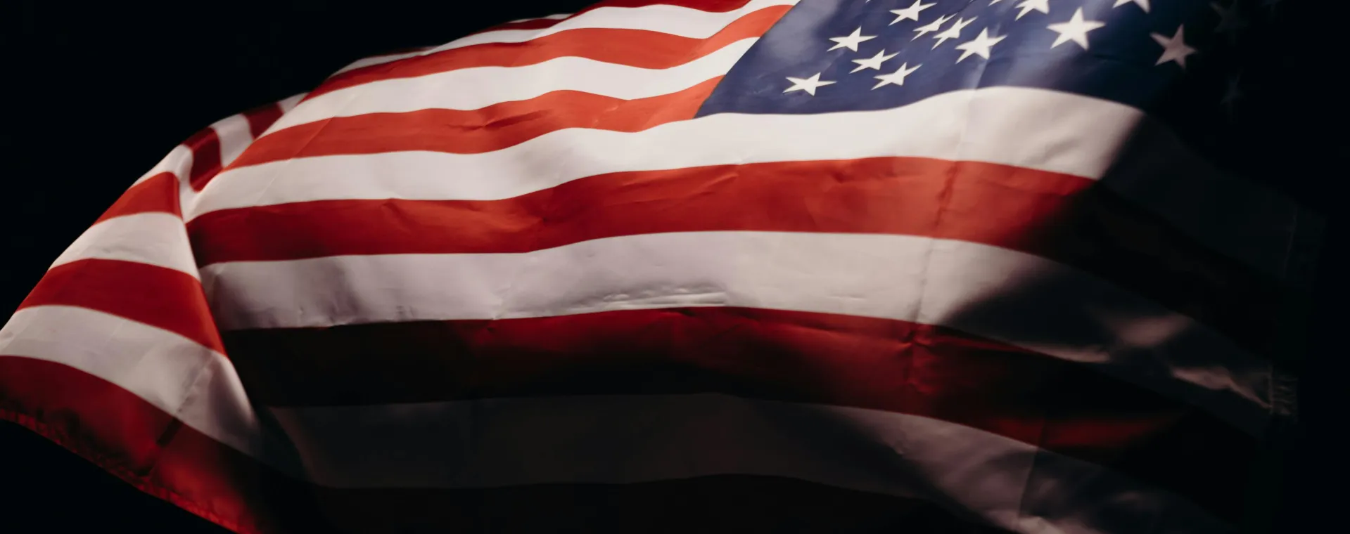 Close-up of a wind-blown American flag symbolizing freedom and patriotism.